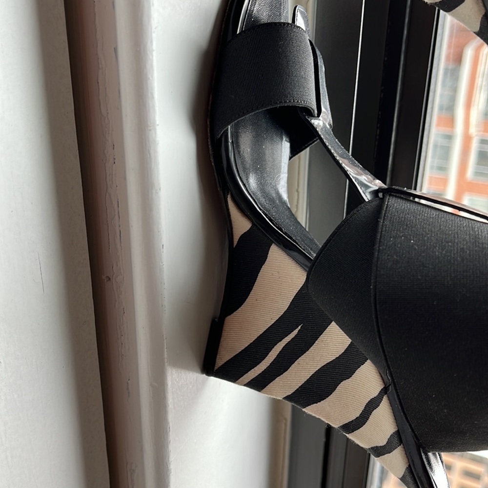 Manola Blahnik black and white patent stretch band strappy wedge.